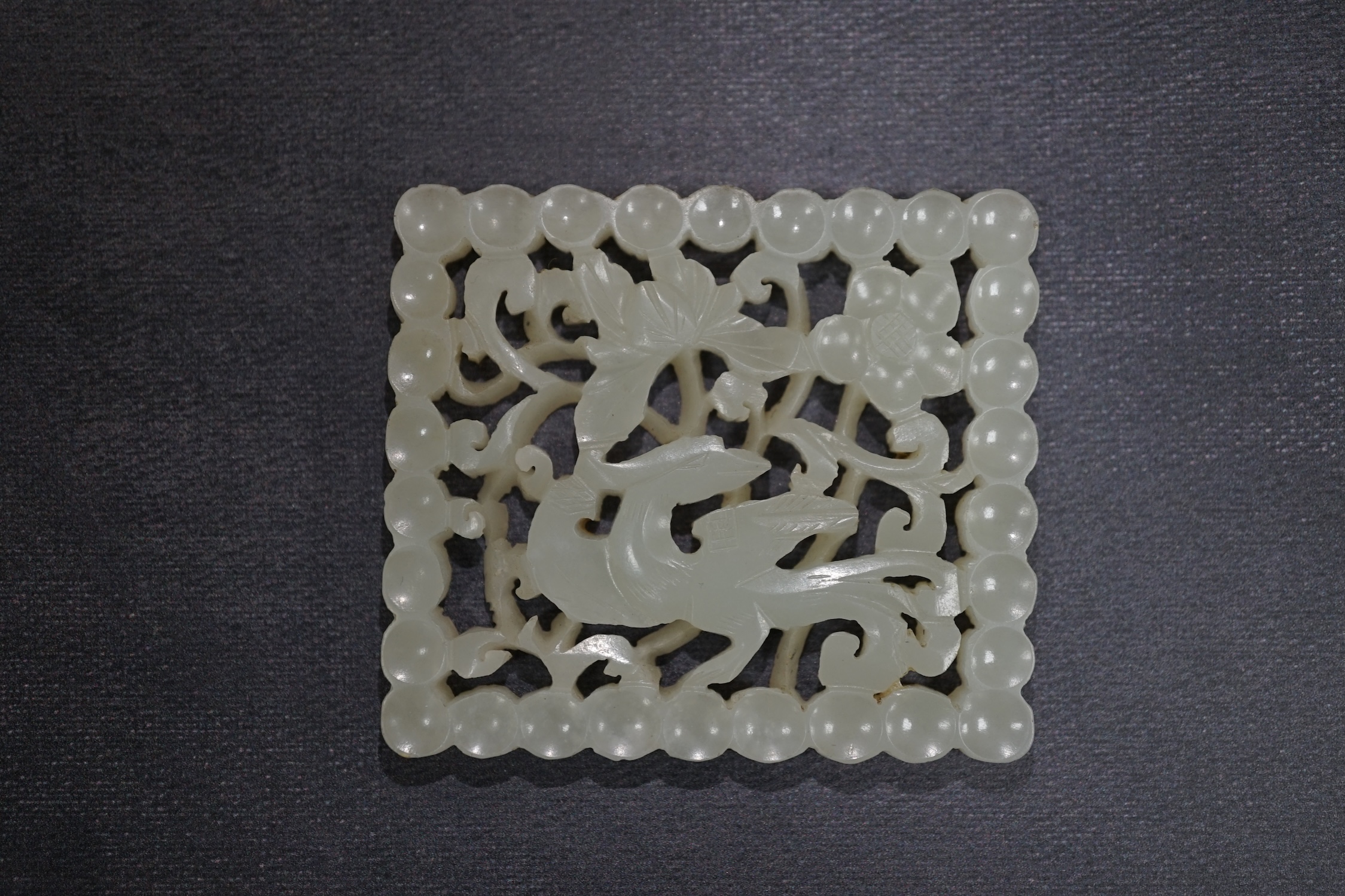 A Chinese pale celadon jade plaque, 17th/18th century, now inset into a hongmu box